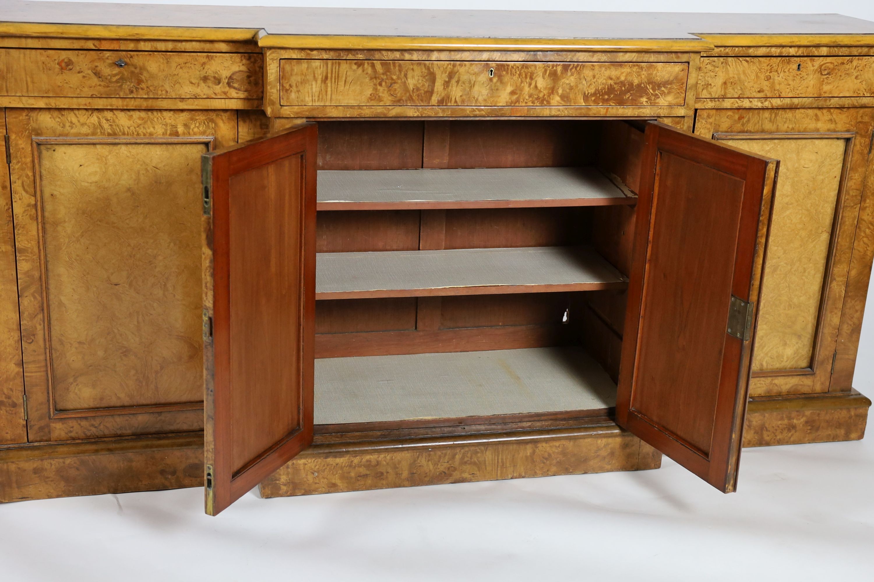 A Victorian walnut breakfront dwarf bookcase, W.195cm D.44cm H.95cm